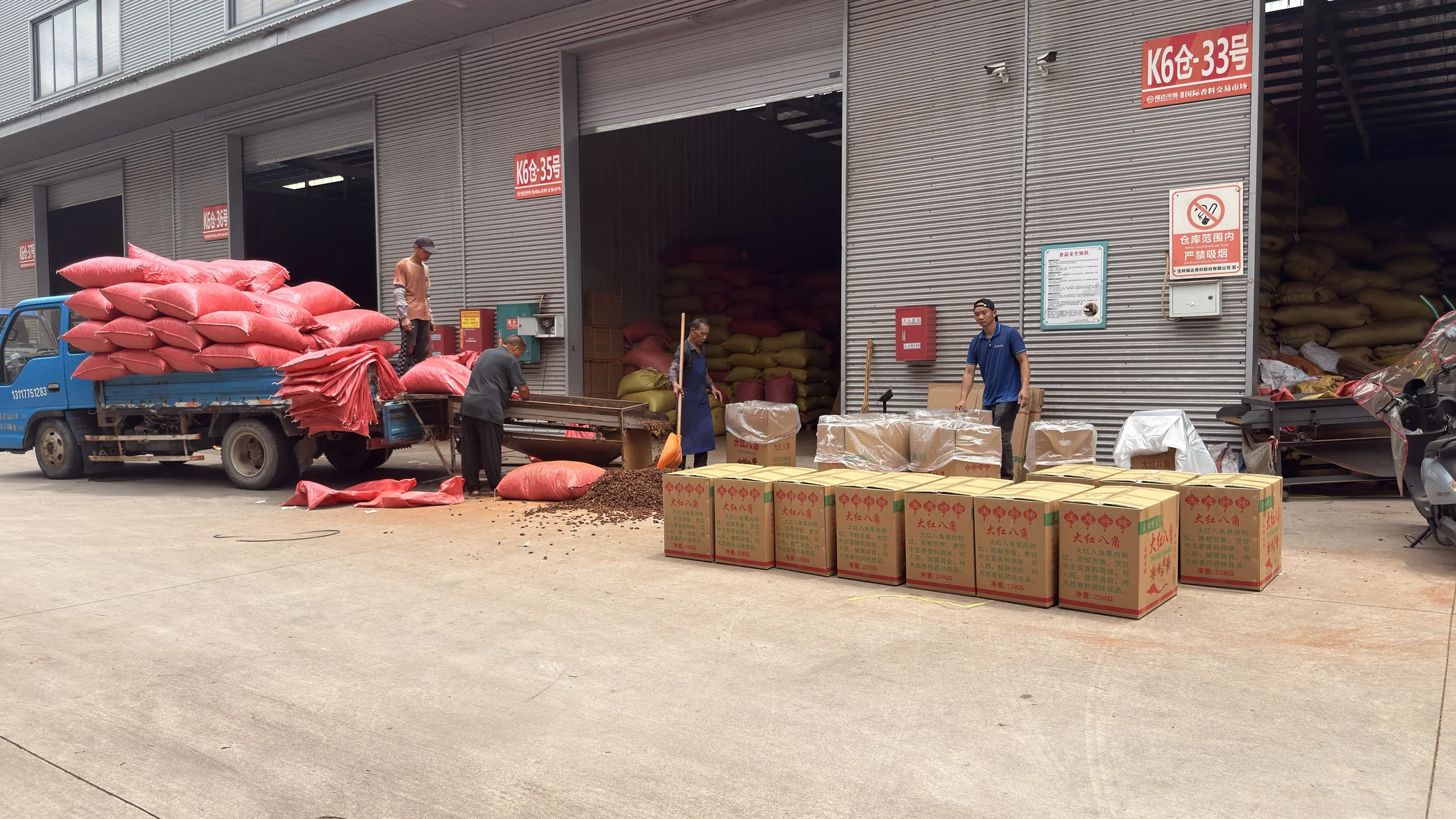 Truck, spice sacks and packed cartons outside warehouse units at Fuda Market