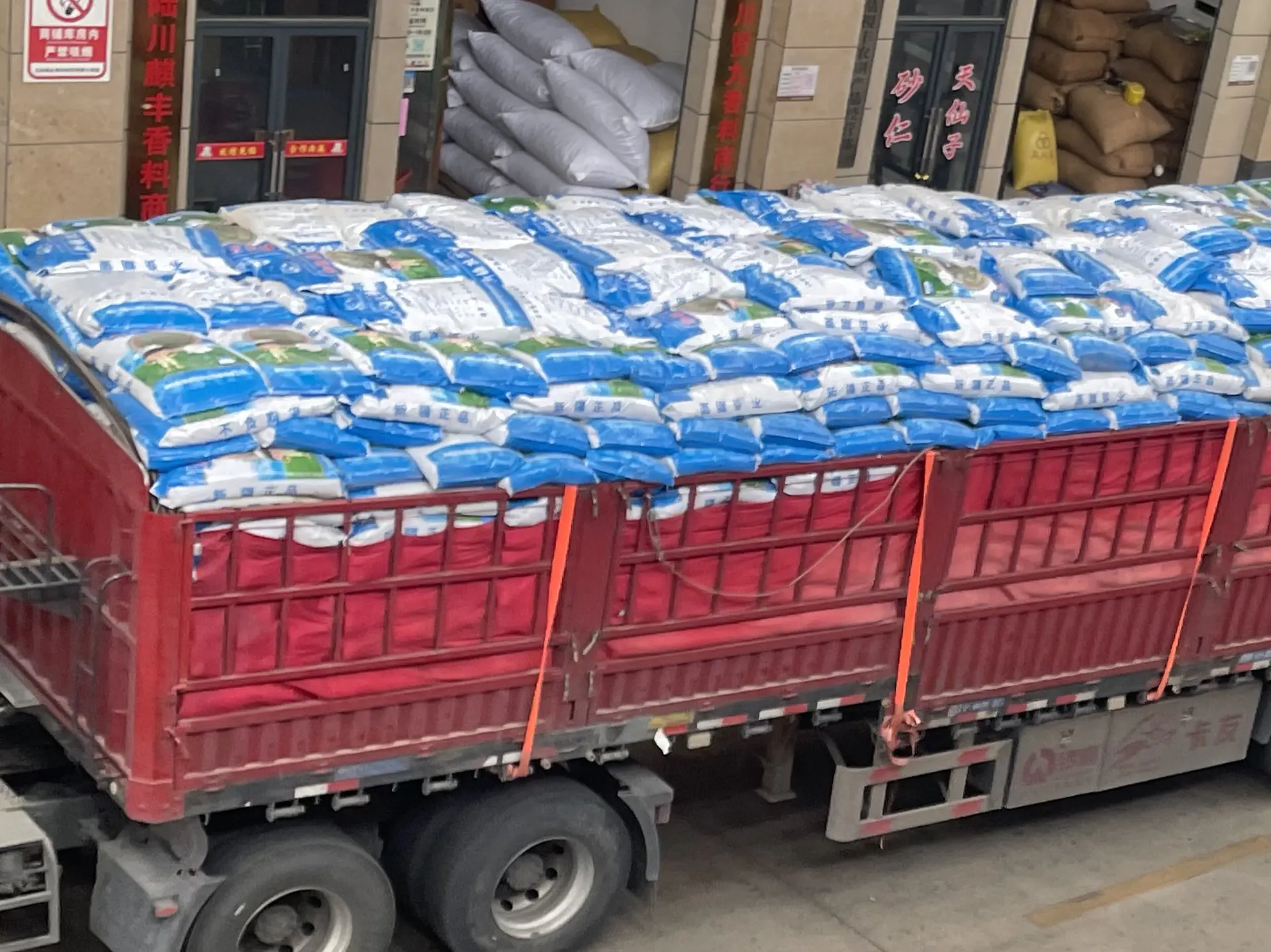 Bagged cumin being unloaded from a truck at the warehouse